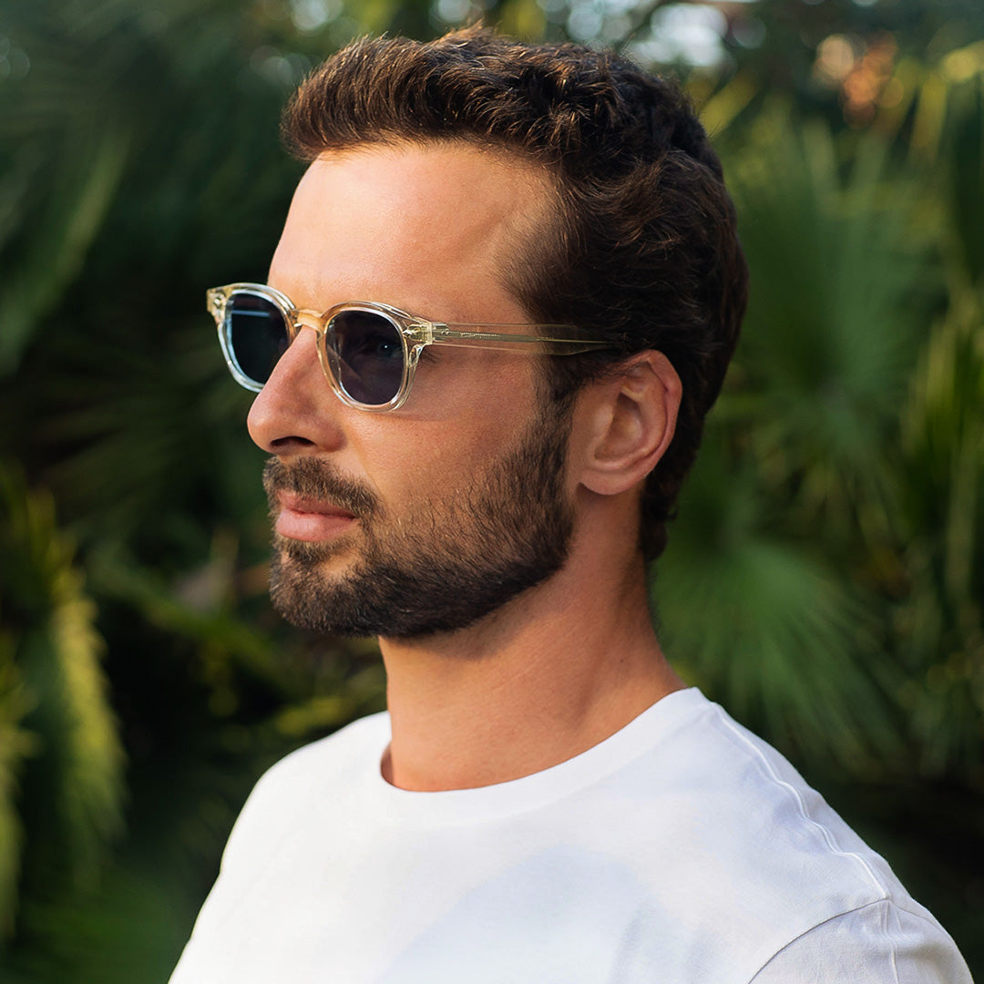 Mireye Fire sunglasses in crystal sand, worn outdoors under natural light.