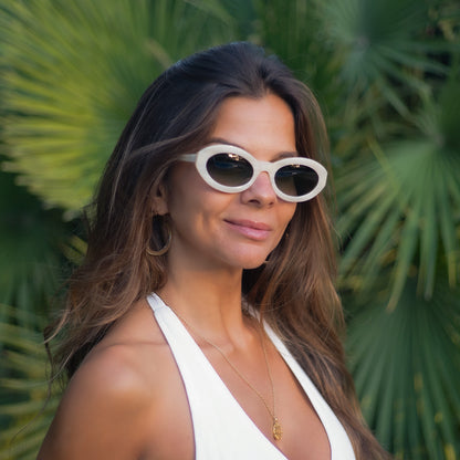 Model wearing the Coolangatta White Pearl sunglasses in translucent white acetate by Mireye.